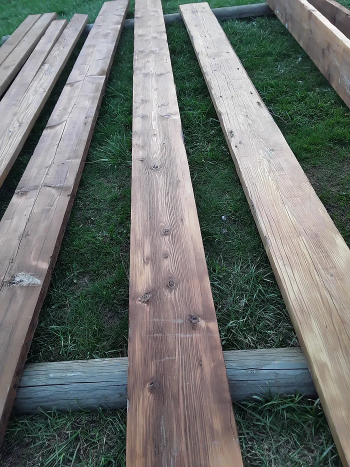 Photo of treating lumber with wood stain. 